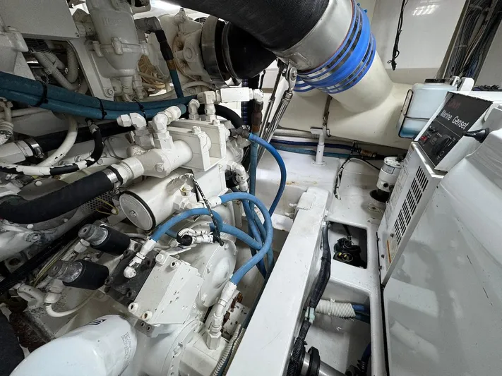  Yacht Photos Pics Engine room of a 2007 Viking 52 Convertibles yacht, showcasing complex machinery and piping.