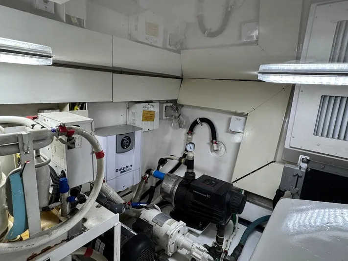  Yacht Photos Pics Engine room of a 2007 Viking 52 Convertibles yacht, showcasing mechanical equipment and piping.