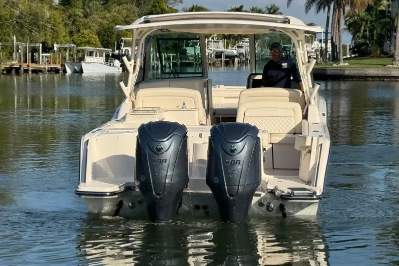  Yacht Photos Pics 2023 Grady-White Freedom 325 boat with dual engines on a calm waterway.