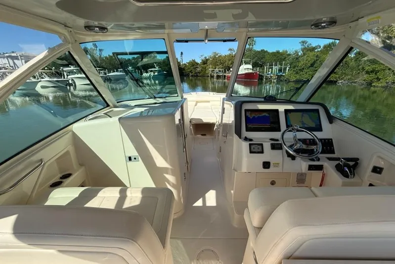  Yacht Photos Pics 2023 Grady-White Freedom 325 boat interior with modern dashboard and seating.