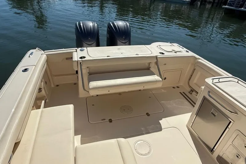  Yacht Photos Pics 2023 Grady-White Freedom 325 boat interior with seating and dual engines.