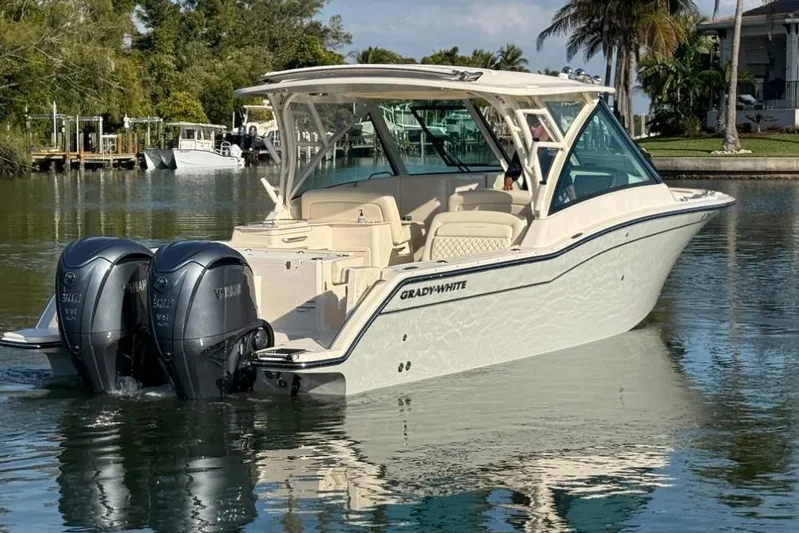  Yacht Photos Pics 2023 Grady-White Freedom 325 boat with dual Yamaha engines on calm water.