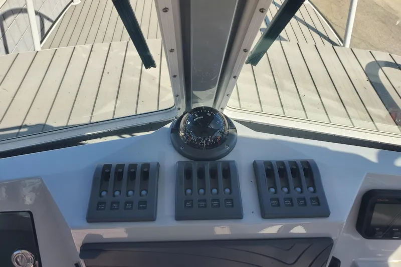  Yacht Photos Pics 1989 Boston Whaler Challenger dashboard with compass and control switches.