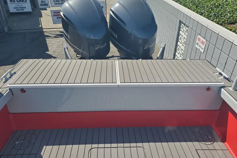  Yacht Photos Pics 1989 Boston Whaler Challenger boat with twin Yamaha 250 engines, docked near a gated area.