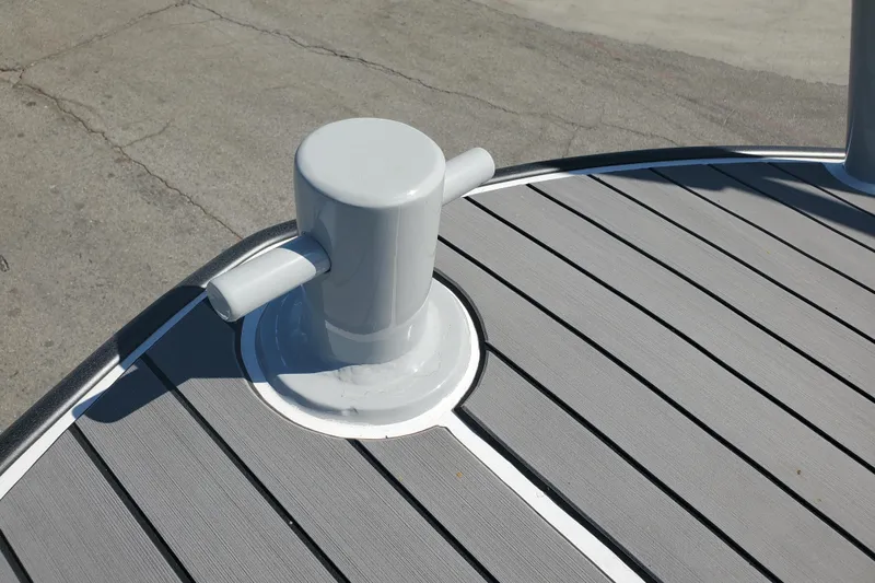  Yacht Photos Pics Boston Whaler Challenger 1989 boat deck with cleat, featuring gray planks and white trim.