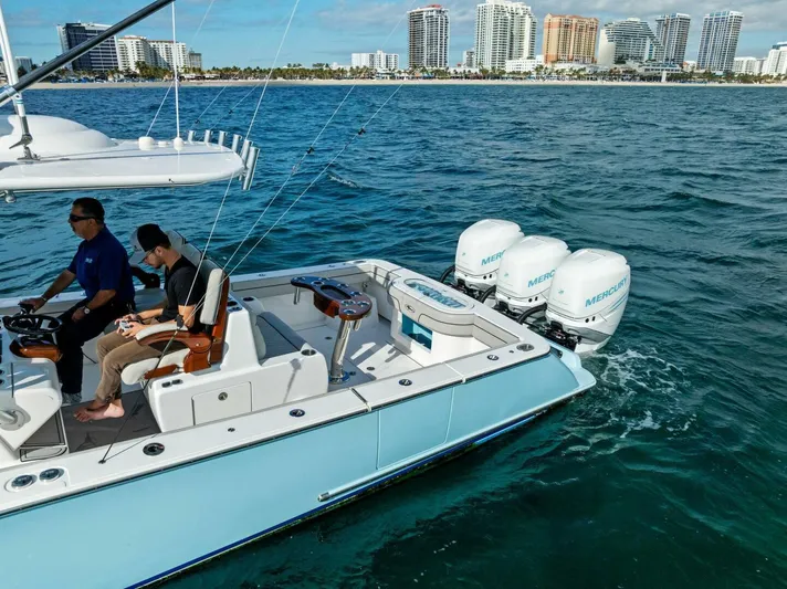  Yacht Photos Pics 2021 Valhalla Boatworks V-37 cruising with twin Mercury engines near city skyline.