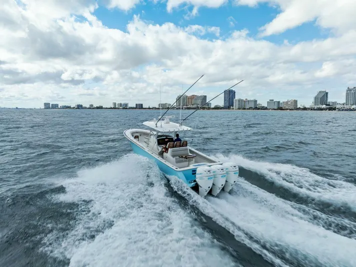  Yacht Photos Pics 2021 Valhalla Boatworks V-37 cruising on open water with city skyline in background.