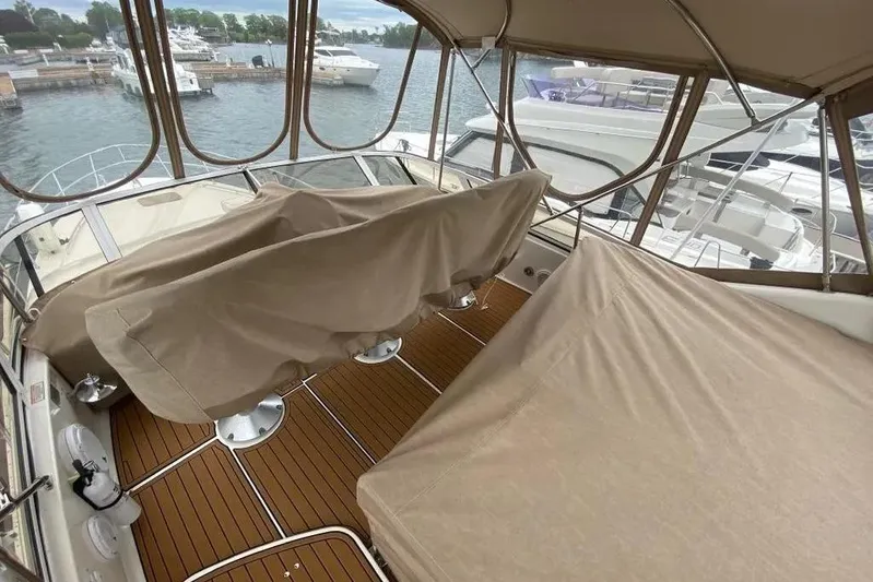  Yacht Photos Pics 2000 Sea Ray 400 Sedan Bridge yacht interior with covered seating and wooden deck.