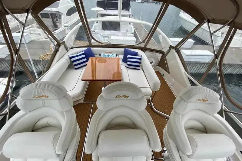  Yacht Photos Pics Luxurious interior of a 2000 Sea Ray 400 Sedan Bridge yacht with plush seating and table.