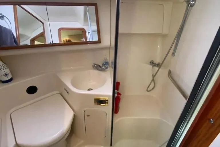  Yacht Photos Pics Bathroom interior of 2000 Sea Ray 400 Sedan Bridge yacht, featuring shower and sink.
