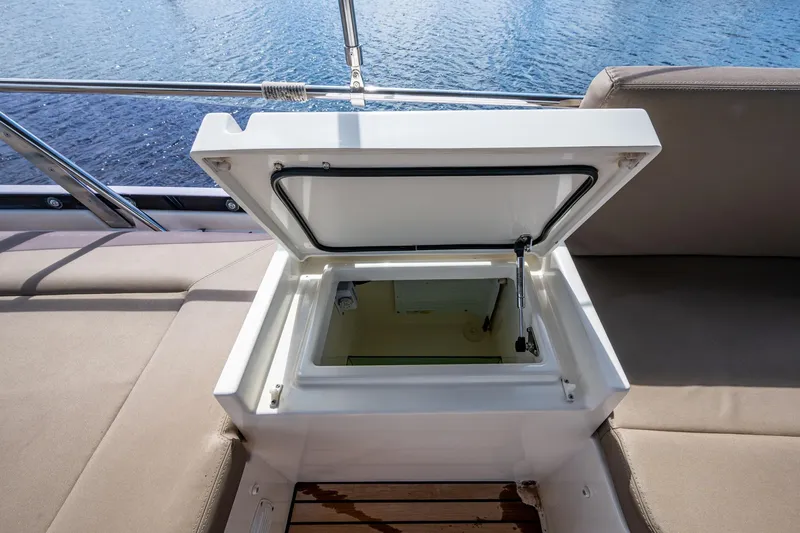  Yacht Photos Pics Open storage compartment on 2012 Prestige Flybridge yacht, overlooking water.