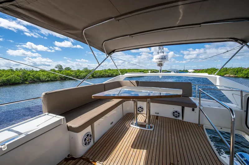  Yacht Photos Pics 2012 Prestige Flybridge yacht deck with seating, table, and scenic water view.