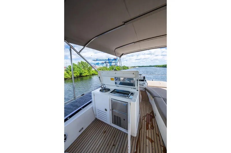  Yacht Photos Pics 2012 Prestige Flybridge yacht with outdoor kitchen on a scenic river.
