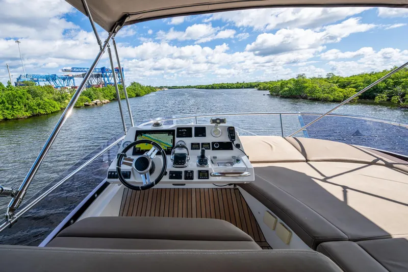  Yacht Photos Pics 2012 Prestige Flybridge yacht helm with scenic river view and clear skies.