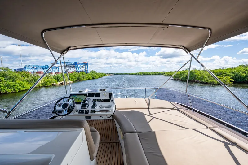  Yacht Photos Pics 2012 Prestige Flybridge yacht helm with river view, featuring modern navigation equipment.