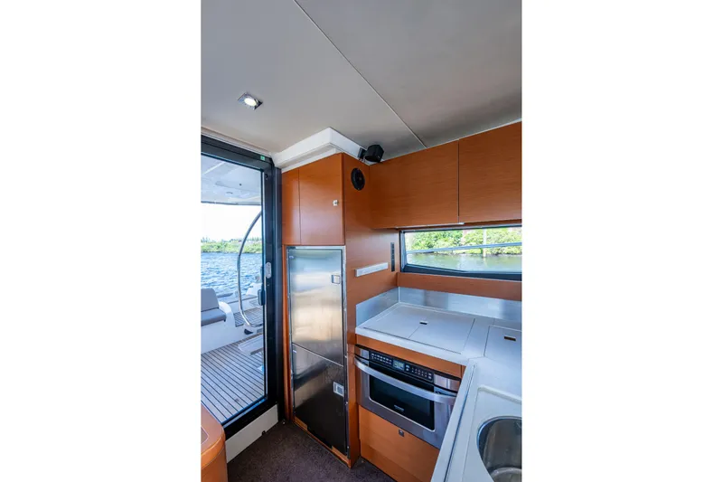  Yacht Photos Pics Interior of 2012 Prestige Flybridge yacht kitchen with modern appliances and scenic window view.