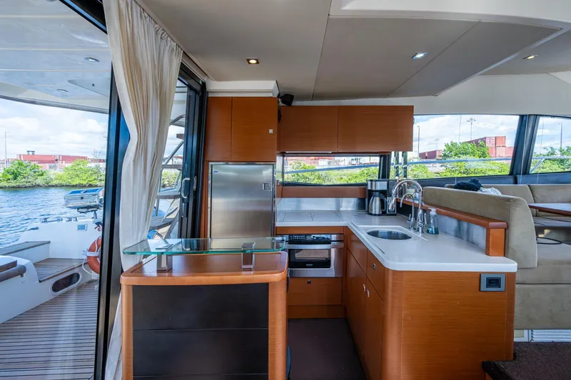  Yacht Photos Pics Luxurious 2012 Prestige Flybridge yacht interior with modern kitchen and scenic water view.