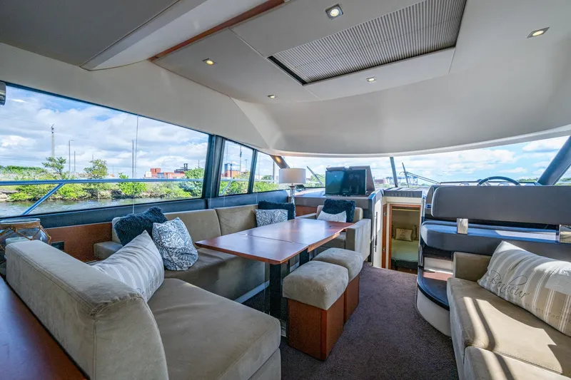  Yacht Photos Pics Luxurious 2012 Prestige Flybridge yacht interior with plush seating and panoramic windows.