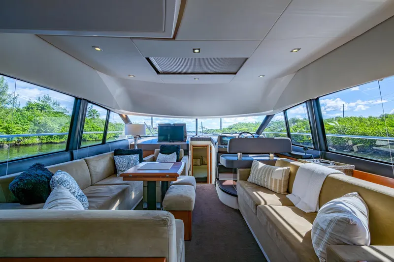  Yacht Photos Pics Luxurious interior of a 2012 Prestige Flybridge yacht with plush seating and panoramic windows.