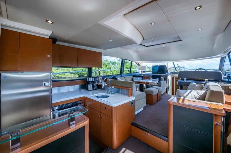  Yacht Photos Pics Luxurious interior of a 2012 Prestige Flybridge yacht with modern kitchen and seating area.