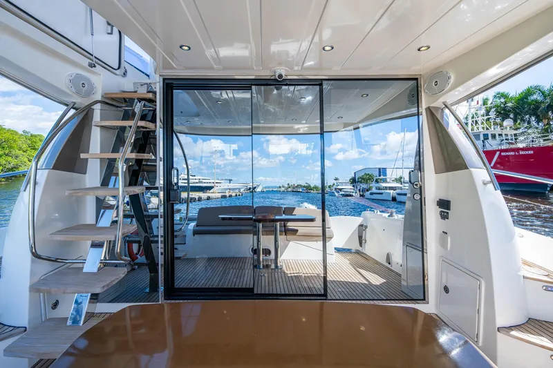  Yacht Photos Pics Luxurious 2012 Prestige Flybridge yacht interior with glass doors and marina view.