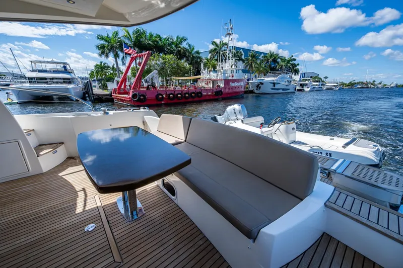  Yacht Photos Pics Luxurious 2012 Prestige Flybridge yacht with elegant seating, docked by scenic waterfront.