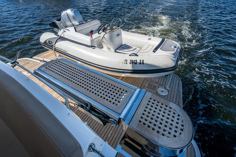  Yacht Photos Pics 2012 Prestige Flybridge yacht with inflatable boat on water, featuring teak deck.