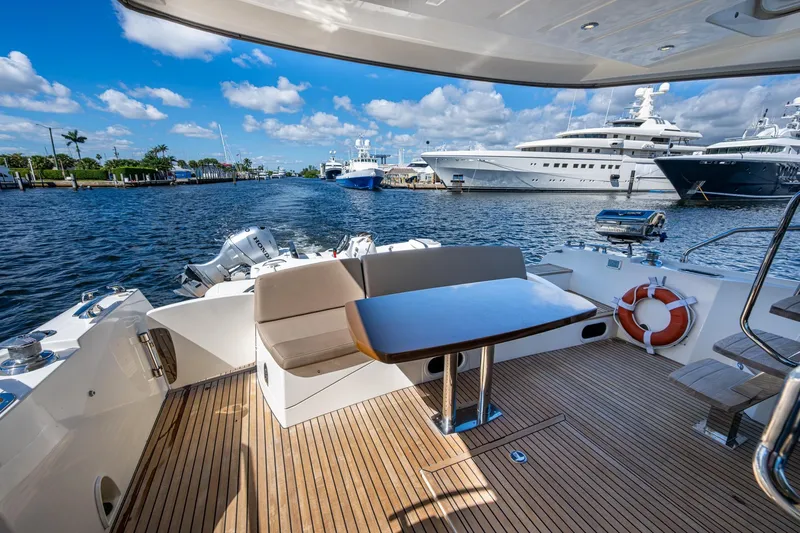  Yacht Photos Pics 2012 Prestige Flybridge yacht deck with seating, table, and ocean view.