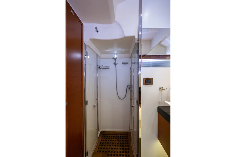  Yacht Photos Pics Luxurious shower area in 2012 Prestige Flybridge yacht, featuring modern fixtures and wooden flooring.