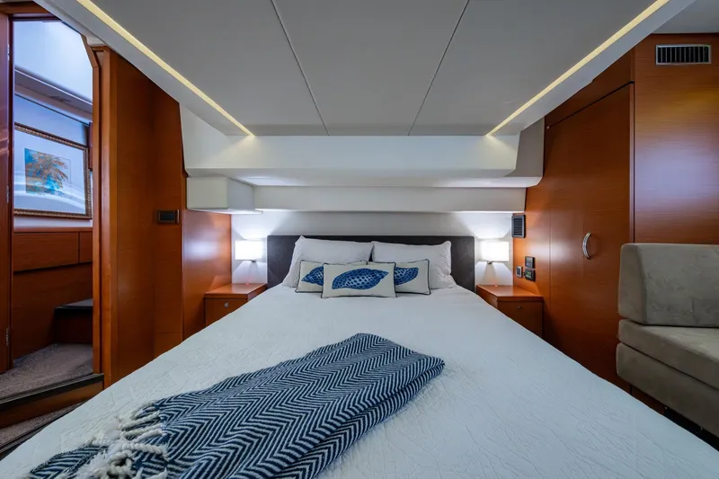  Yacht Photos Pics Luxurious bedroom interior of 2012 Prestige Flybridge yacht with modern design and cozy bedding.