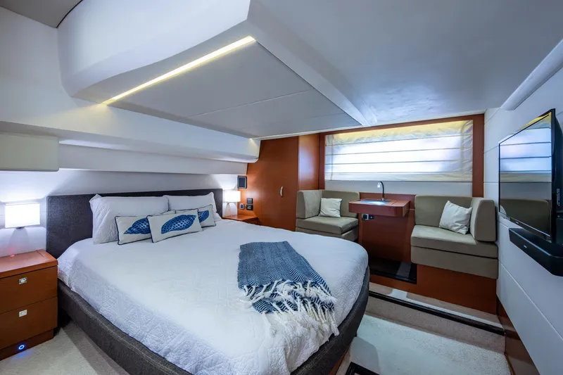  Yacht Photos Pics Luxurious 2012 Prestige Flybridge yacht bedroom with modern decor and cozy seating area.