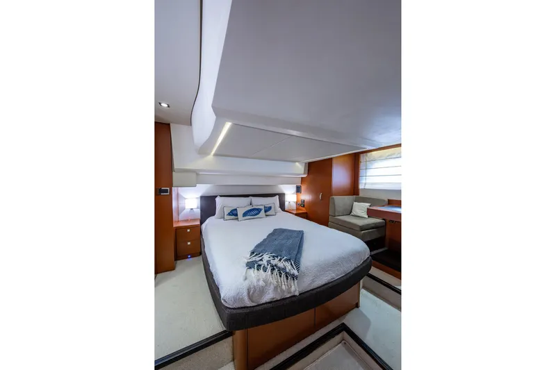  Yacht Photos Pics Luxurious bedroom interior of 2012 Prestige Flybridge yacht with modern design and cozy furnishings.