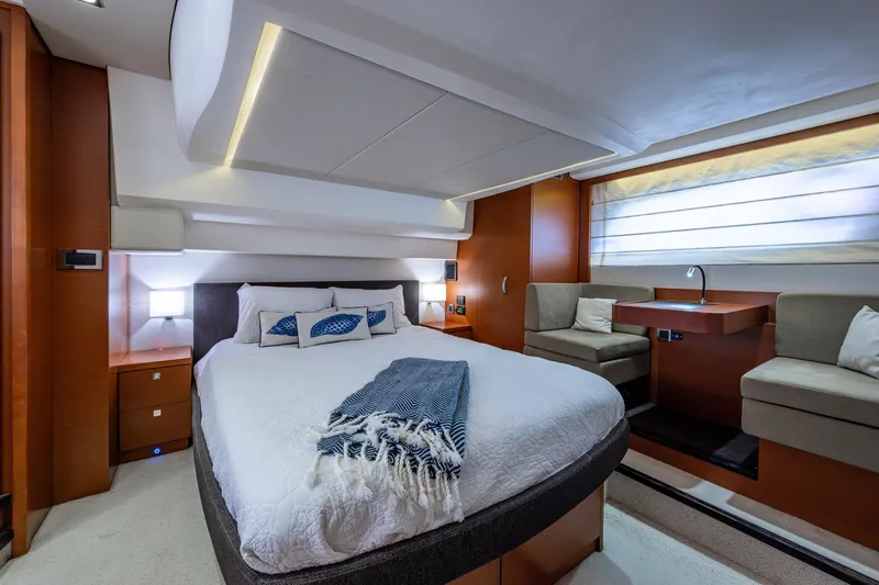  Yacht Photos Pics Luxurious bedroom interior of 2012 Prestige Flybridge yacht with modern design and cozy seating area.