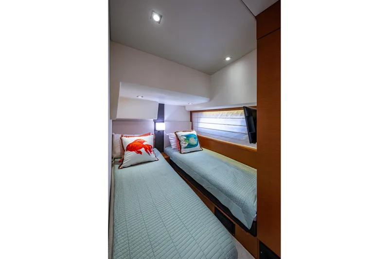  Yacht Photos Pics Twin beds in a 2012 Prestige Flybridge yacht cabin with decorative pillows.