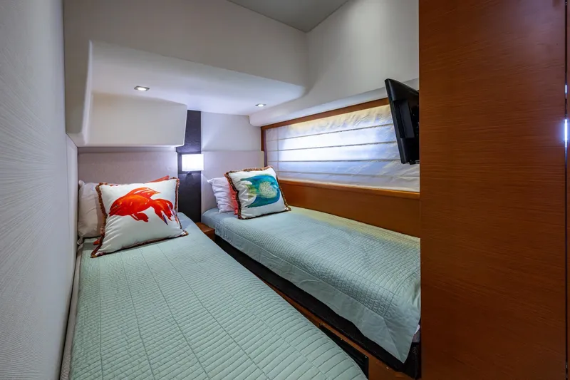  Yacht Photos Pics 2012 Prestige Flybridge yacht cabin with twin beds and decorative pillows.