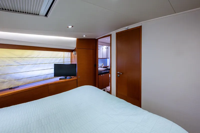  Yacht Photos Pics Luxurious bedroom interior of 2012 Prestige Flybridge yacht with modern amenities.