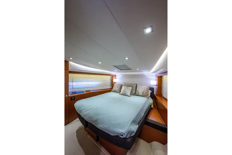  Yacht Photos Pics Luxurious bedroom interior of 2012 Prestige Flybridge yacht with modern lighting and cozy bedding.