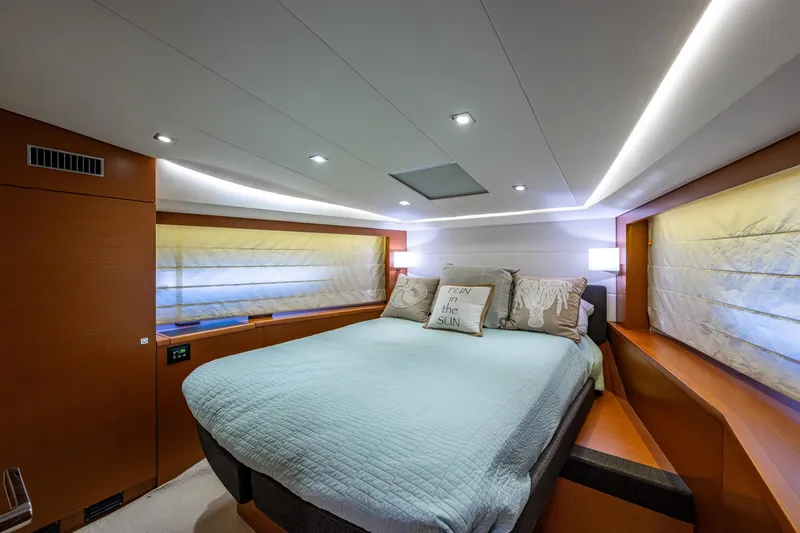  Yacht Photos Pics Luxurious bedroom interior of 2012 Prestige Flybridge yacht with modern lighting and cozy bedding.