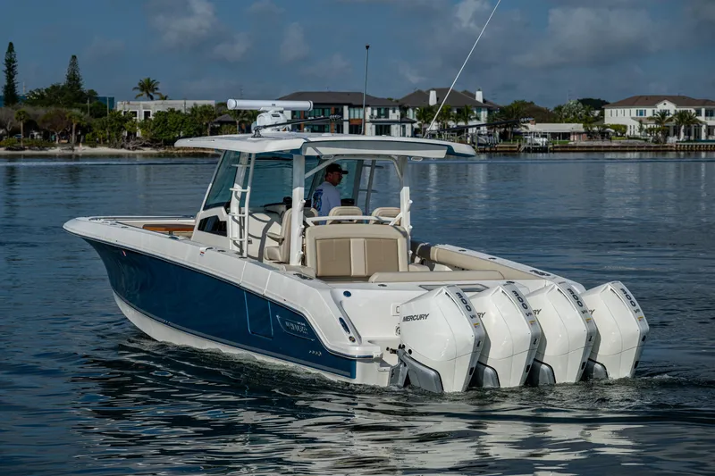  Yacht Photos Pics 2024 Boston Whaler 380 Outrage boat cruising on calm water, featuring powerful engines.