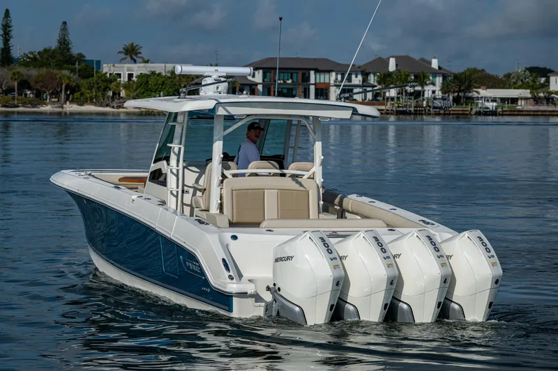  Yacht Photos Pics 2024 Boston Whaler 380 Outrage boat with triple engines on calm water.