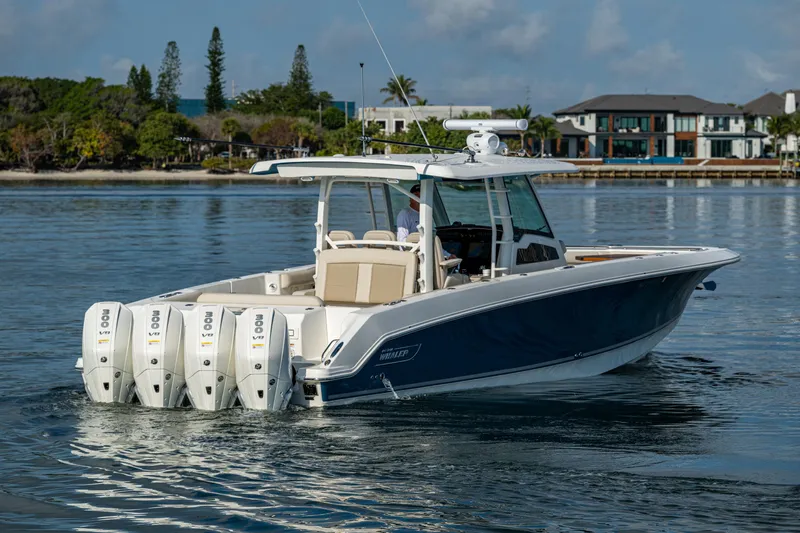  Yacht Photos Pics 2024 Boston Whaler 380 Outrage boat with four engines on calm water.