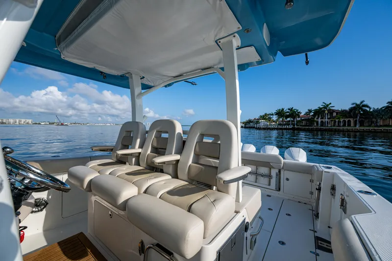  Yacht Photos Pics 2024 Boston Whaler 380 Outrage boat interior with luxurious seating and scenic water view.