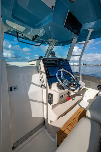  Yacht Photos Pics 2024 Boston Whaler 380 Outrage helm with modern controls and ocean view.
