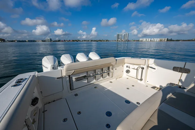  Yacht Photos Pics 2024 Boston Whaler 380 Outrage boat deck with scenic waterfront view.