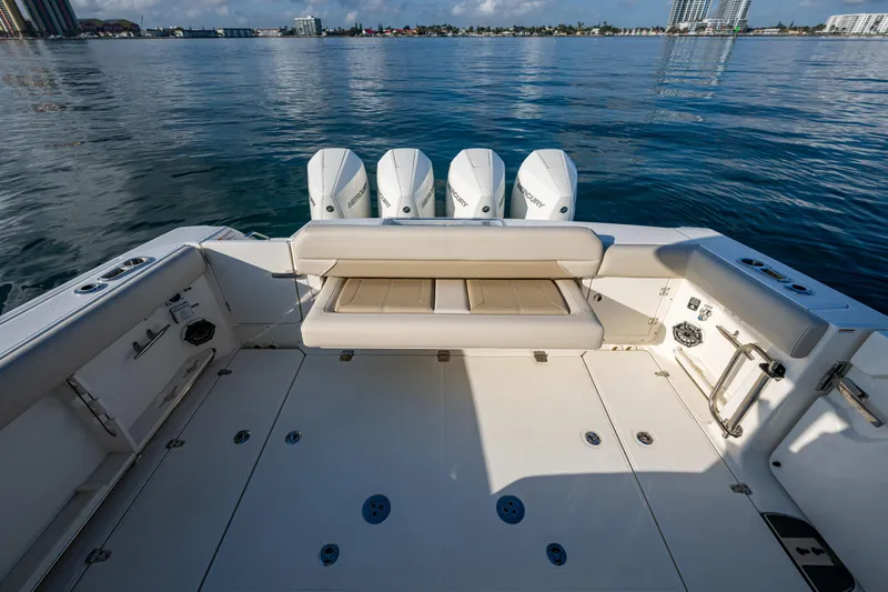  Yacht Photos Pics 2024 Boston Whaler 380 Outrage boat deck with quad engines, on calm water.