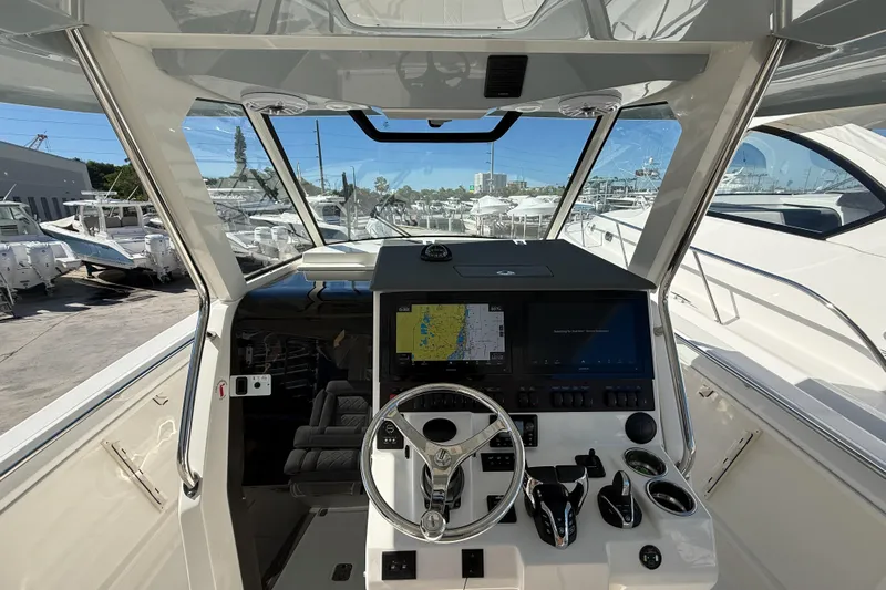  Yacht Photos Pics 2025 Pursuit S 358 Sport boat cockpit with advanced navigation system and steering wheel.