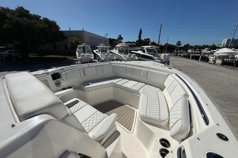  Yacht Photos Pics 2025 Pursuit S 358 Sport boat with luxurious seating and modern design in a marina setting.