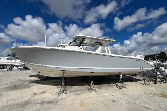  Yacht Photos Pics 2026 Pursuit S 358 Sport boat on stands under a blue sky.