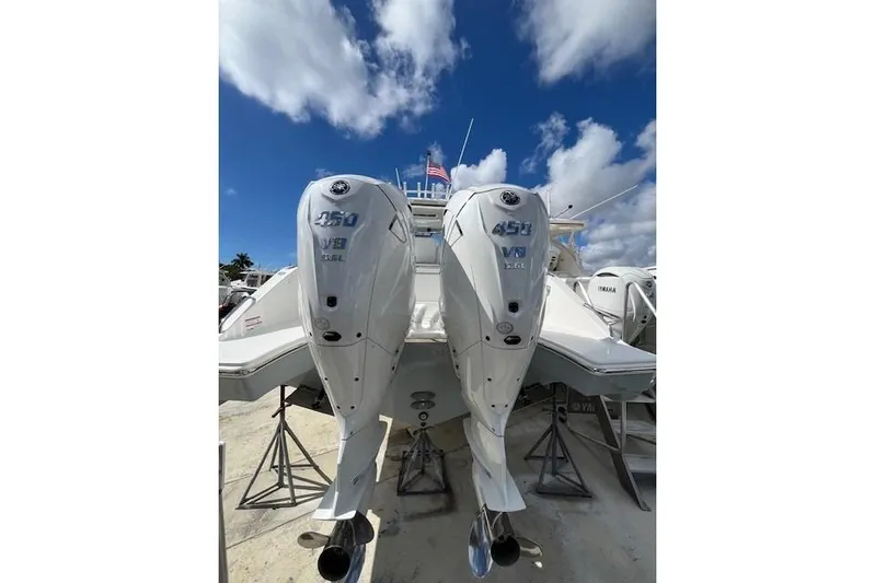  Yacht Photos Pics 2026 Pursuit S 358 Sport boat with twin 450 V8 engines under a blue sky.