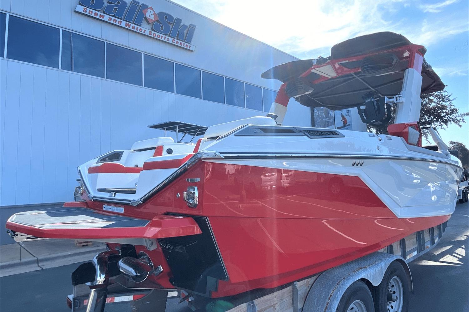2023 Nautique Super Air Nautique G25 Paragon boat in red and white at Sail & Ski Center.